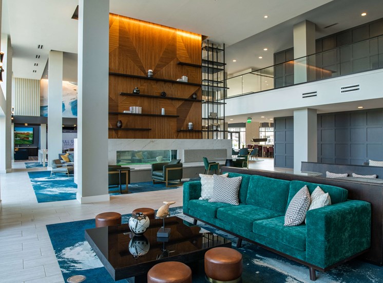 atrium with long teal couches and brown coffee tables